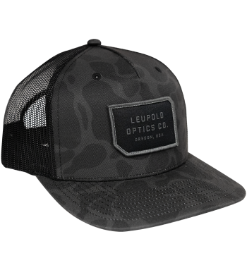 Snapback Trucker hat with dark gray camo colorway. Patch on front with words "Leupold Optics Co. Oregon, USA". Great hat for fishing, hunting, and spending time in the outdoors. It has a pre-curved bill and adjustable one size fits all. 