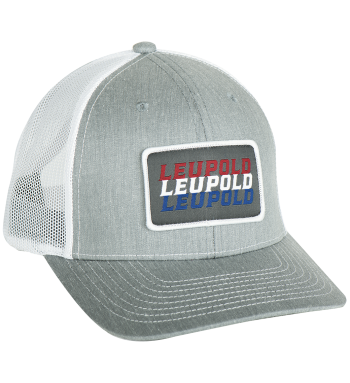 Gray and white Snapback Trucker with patch on front. Patch has the word Leupold three times in colors red, blue, and white. Pre curved and adjustable one size fits all. 