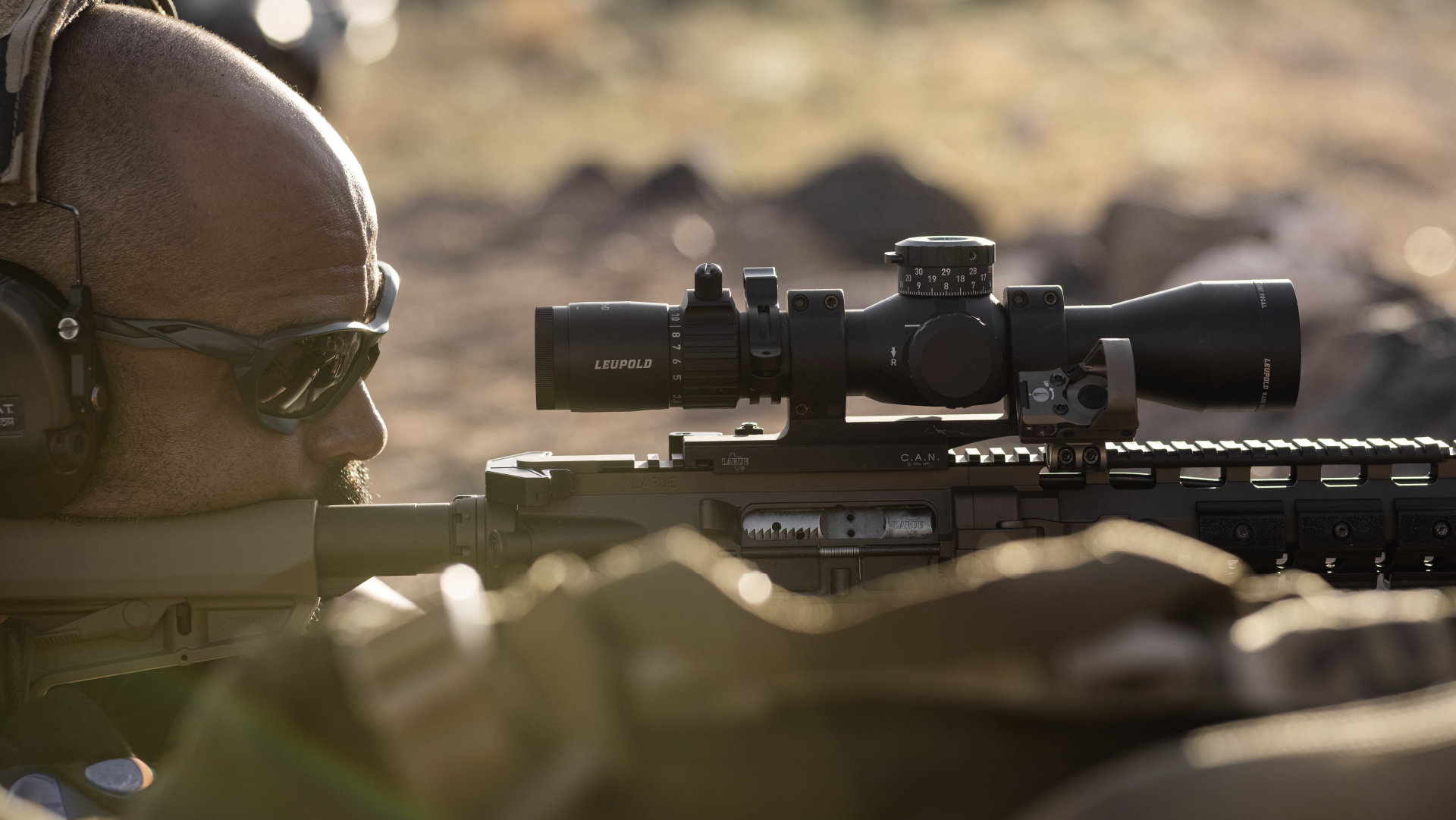 man laying down shooting a mark 5hd riflescope with PR2 reticle mounted on long gun 