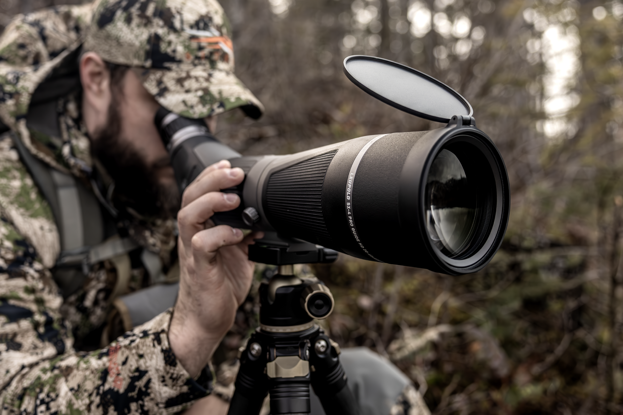 hunter in camo sitting behind leupold sx-4 pro guide hd gen 2 spotting scope