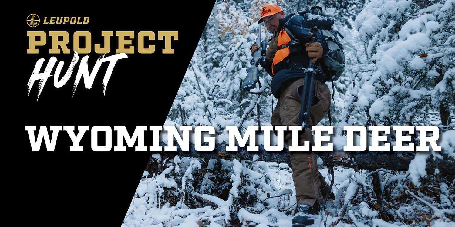 Hunter walking through snowy wilderness on a Leupold hunt.