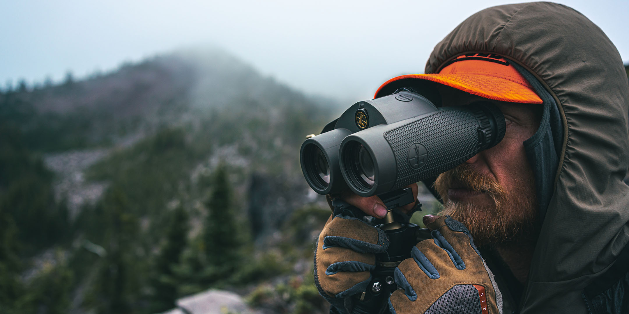 Up-close product image of the new Leupold BX-4 Range HD Rangefinding Binoculars being held in the rain.