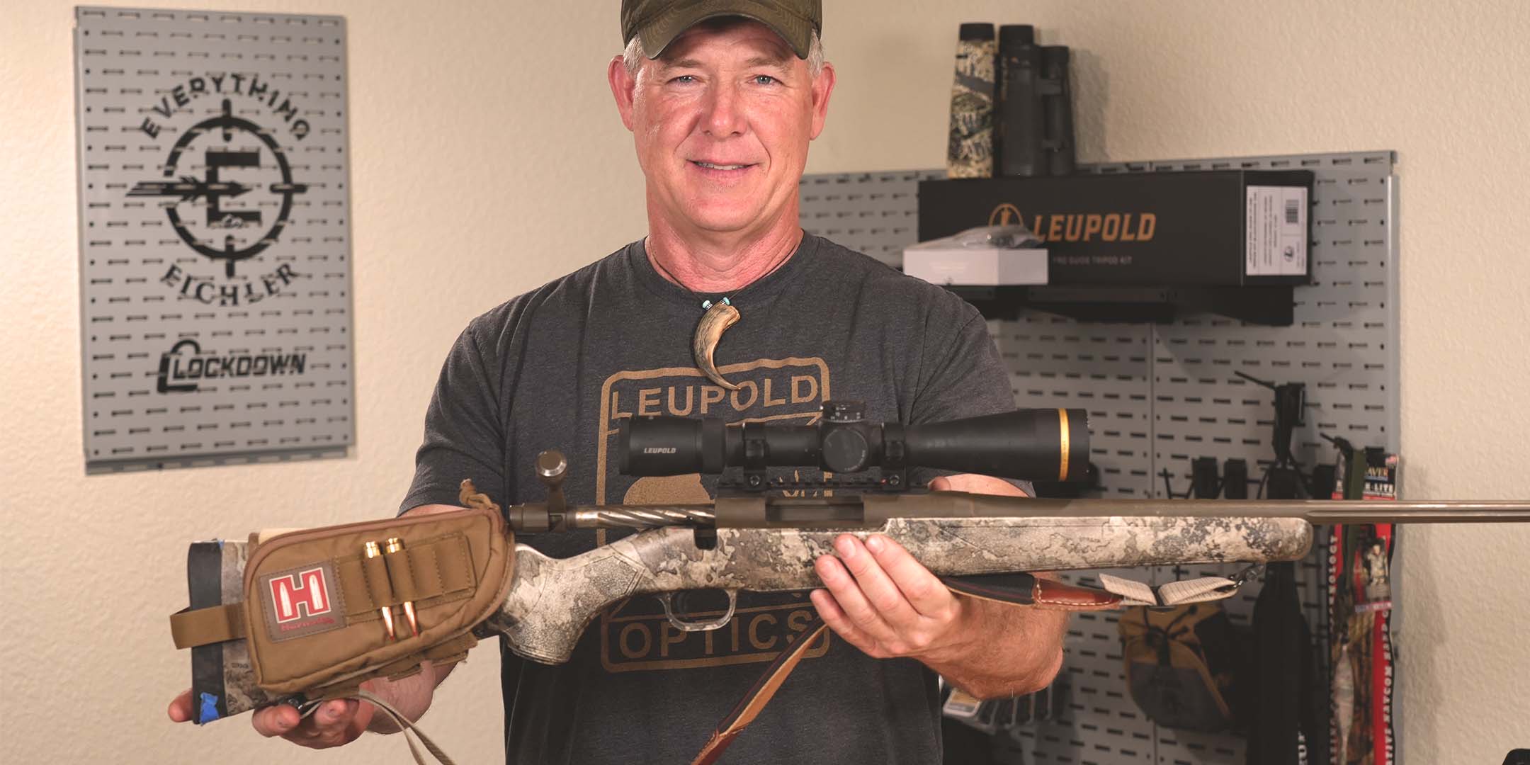 Male shooter holding a rifle topped with a leupold vx-6hd riflescope.