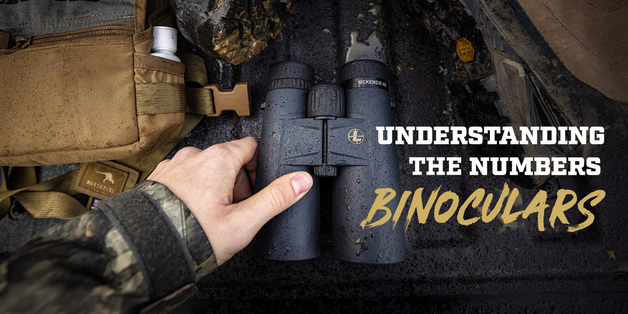 An up-close image of a hand picking up a pair Leupold binoculars.