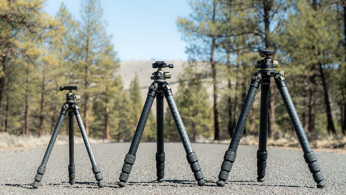 Three different models of Leupold's carbon fiber tripods on display in the forest.