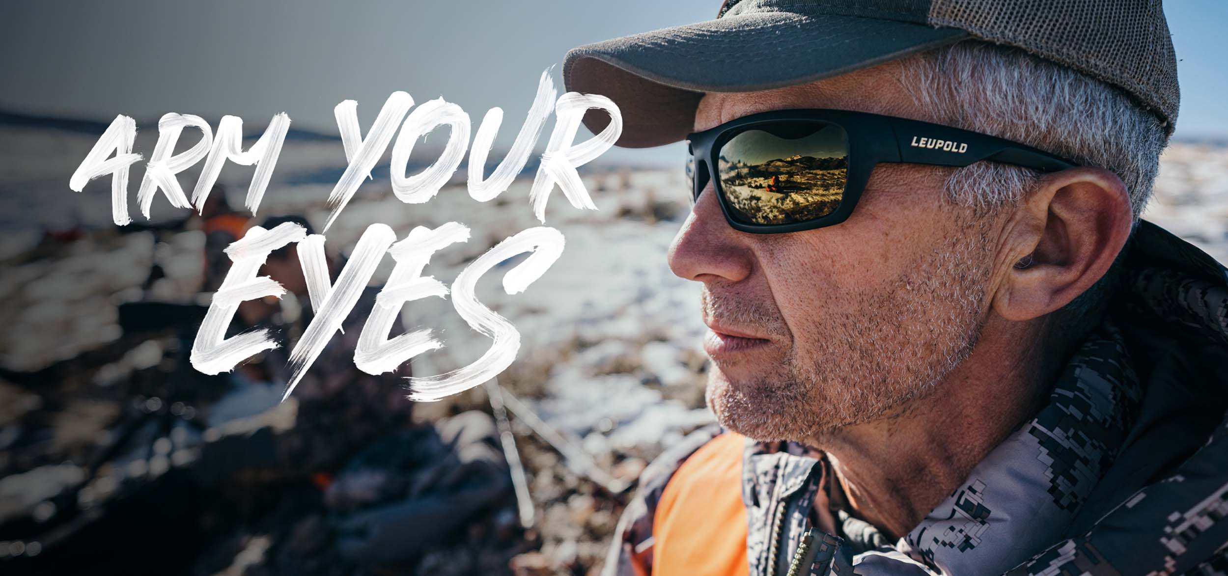 Upclose image of man standing outside in sunshine wearing Leupold performance eyewear sunglasses.