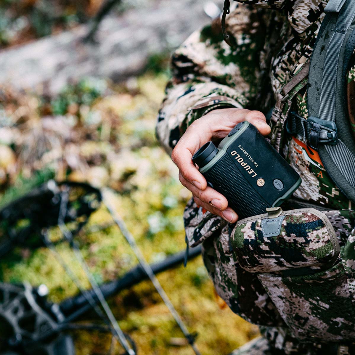 Person taking aim with a semi-automatic rifle with a Freedom Red Dot Sight mounted on top.