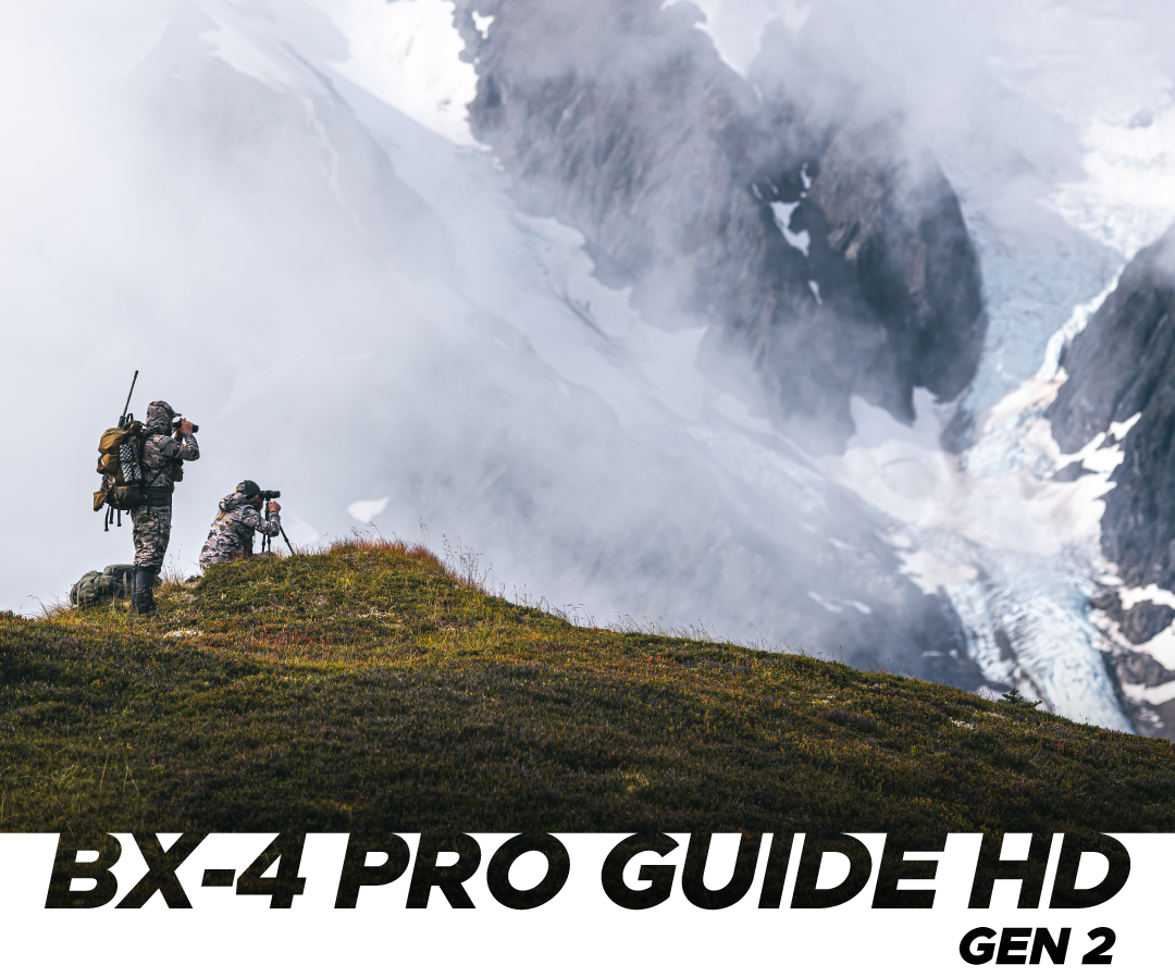 image of hunters on cliff edge looking at mountain landscape through leupold bx-4 pro guide hd gen 2 binoculars