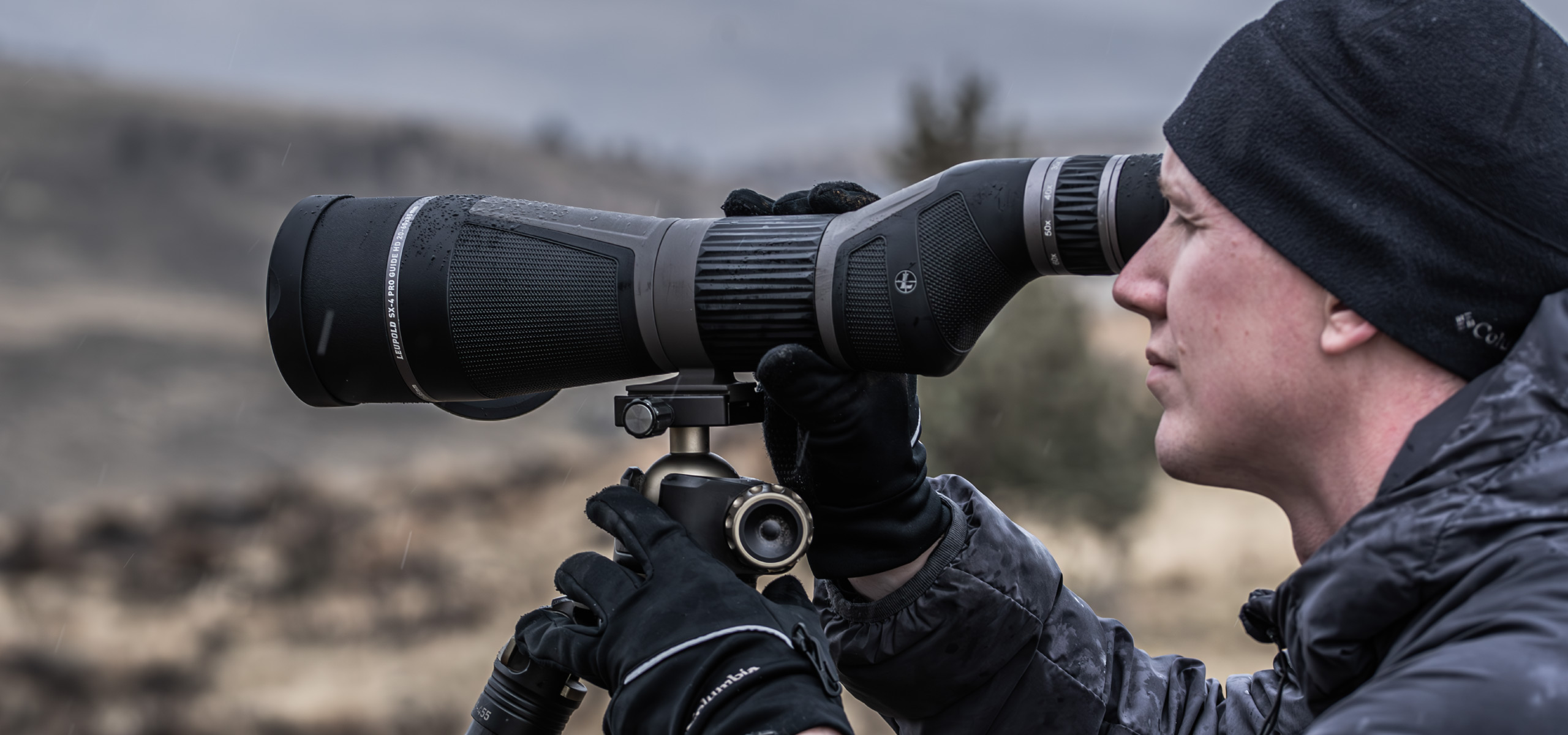 man on hill looking through leupold sx-4 pro guide hd gen 2 spotting scope on tripod