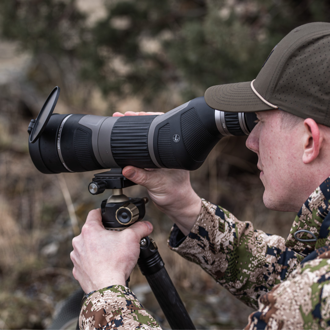 man on hill looking through leupold sx-4 pro guide hd gen 2 spotting scope on tripod