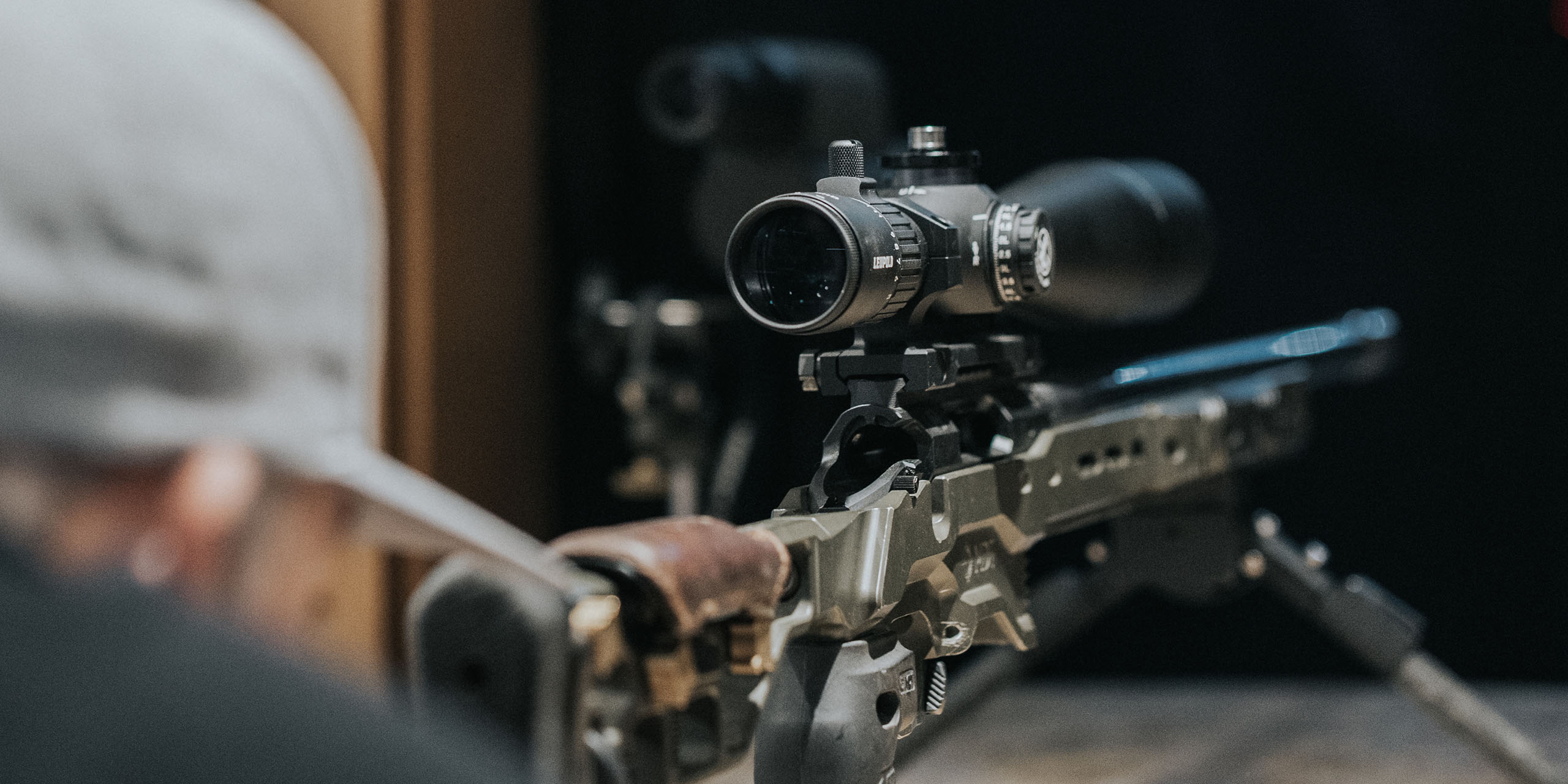 Focus on Leupold riflescope at shooting range.