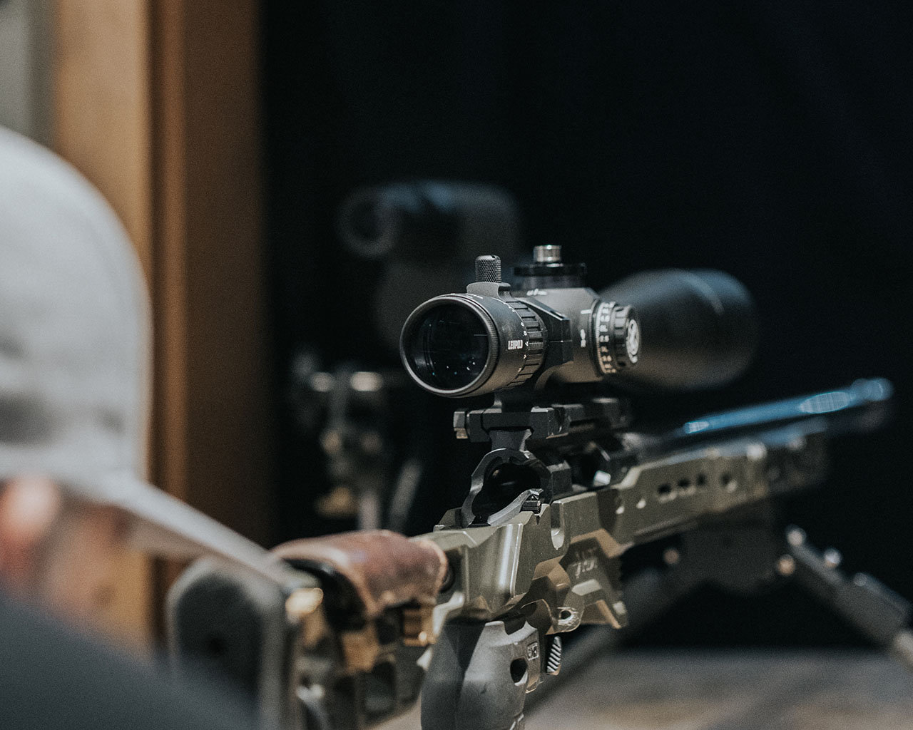 Focus on Leupold riflescope at shooting range.